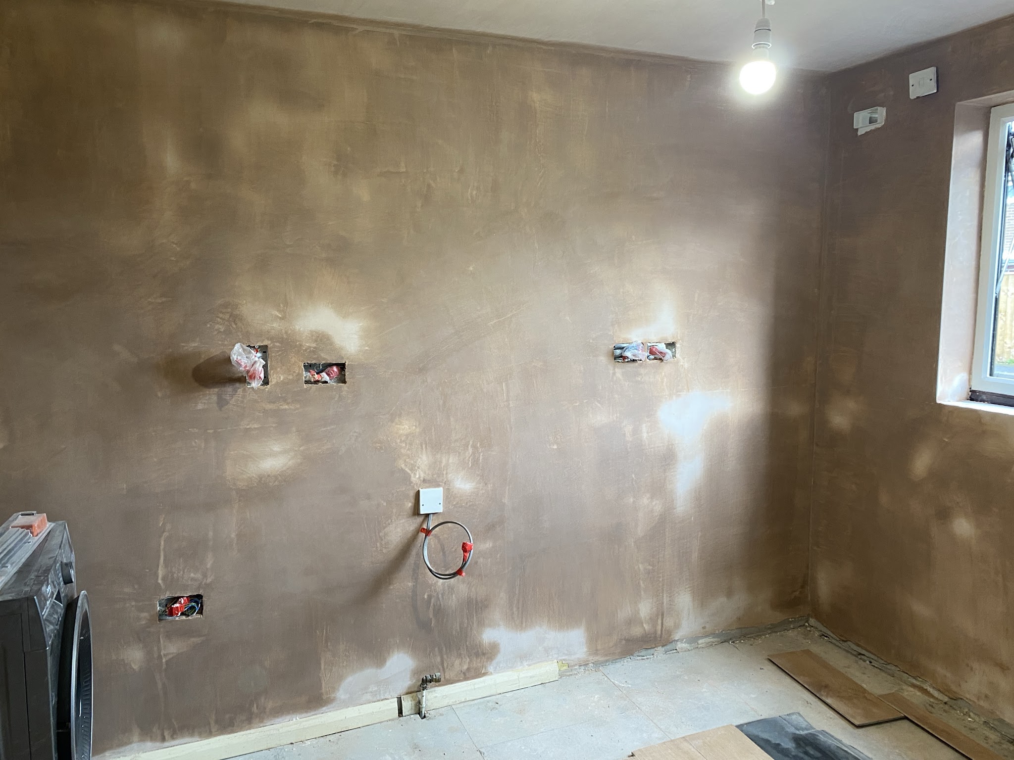Sophie’s kitchen after: every wall freshly plastered, sockets boxed out, ready for the new kitchen