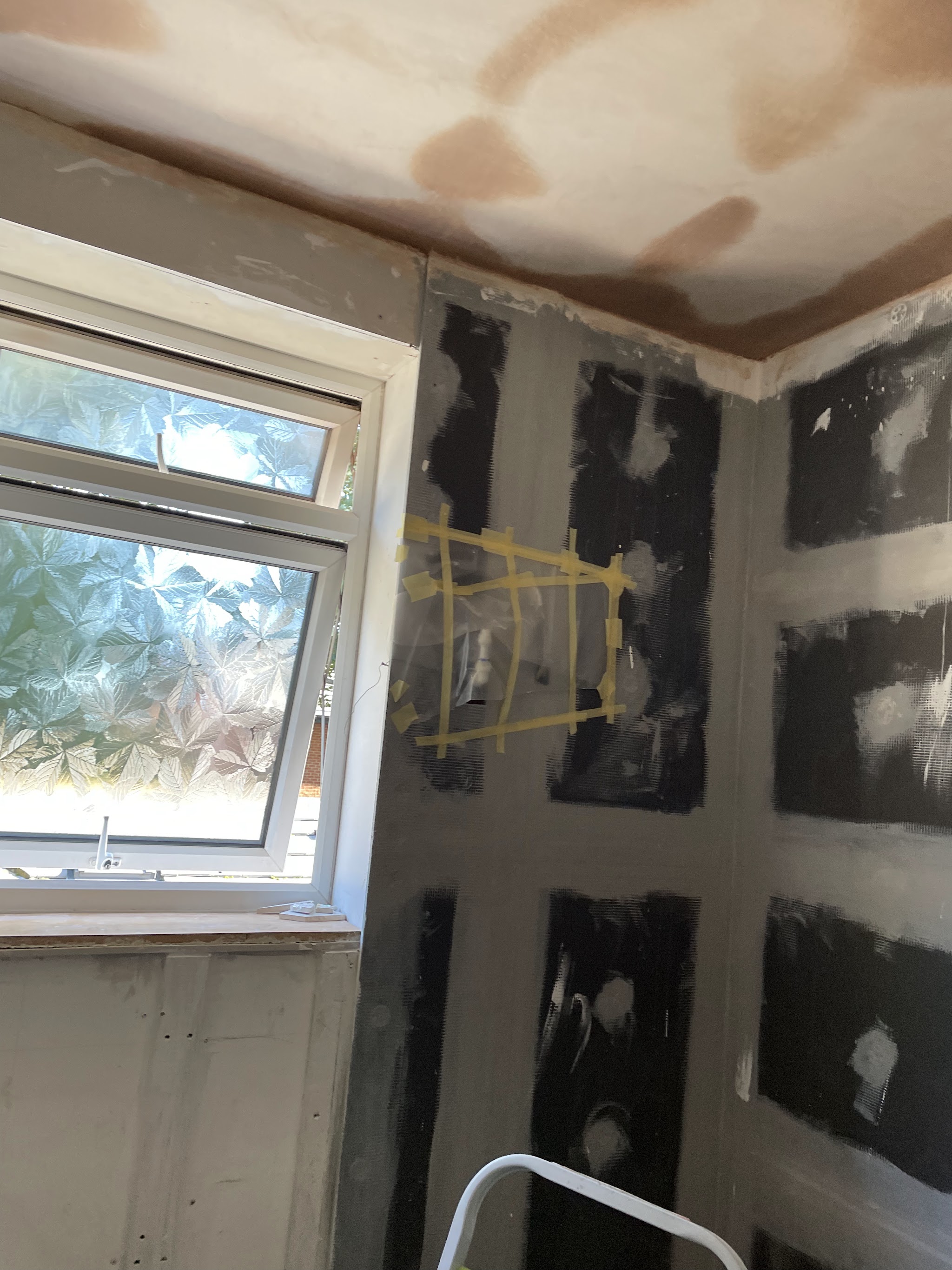 Bathroom mid-job: ceiling skimmed, walls boarded and meshed ready for tiling